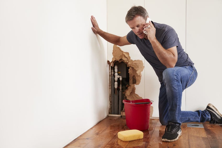 a man on the phone with a burst pipe | burlington nj plumber